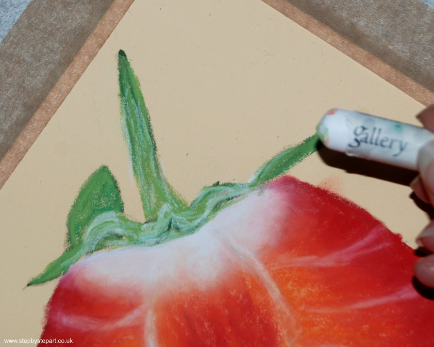Applying a White oil pastel over the green stem of a Strawberry drawing