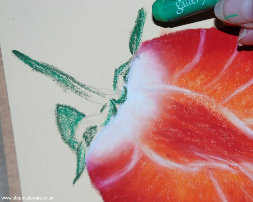 Applying a grass green oil pastel over the green stem of a Strawberry drawing