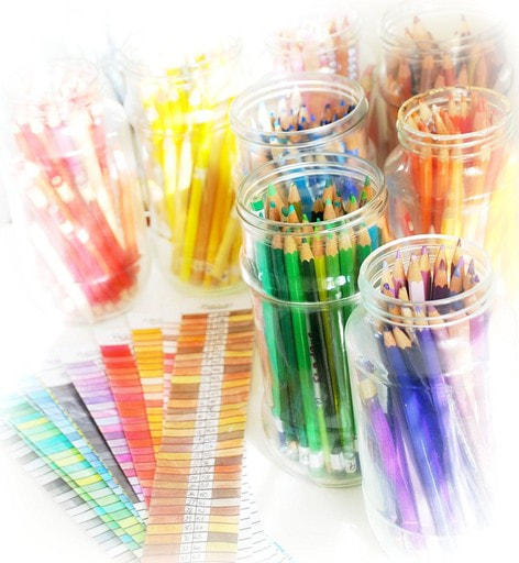 coloured pencils in glass jars and colour charts