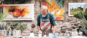 artist working with paints at a table