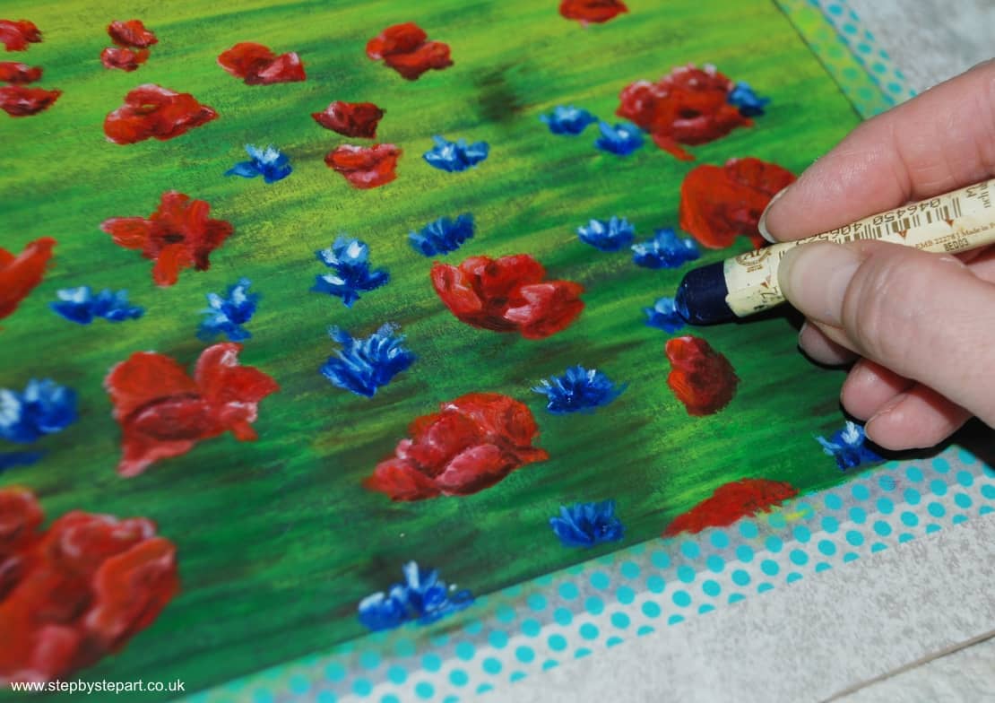 Creating dark contrasts on the cornflowers with the French Ultramarine Sennelier oil pastels 