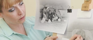 Artist Karen M Berisford drawing a Boxer pup in Graphite pencils