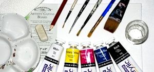 Collection of acrylic paint products includes paint tubes, paintbrushes, canvas, paint palette and accessories