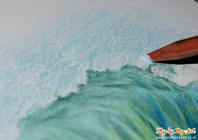 Applying the final layers of a coloured pencil drawing of waves using Derwent Lightfast pencils