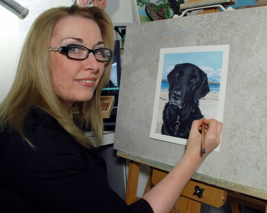 Artist Karen M Berisford with a coloured pencil Black Labrador drawing