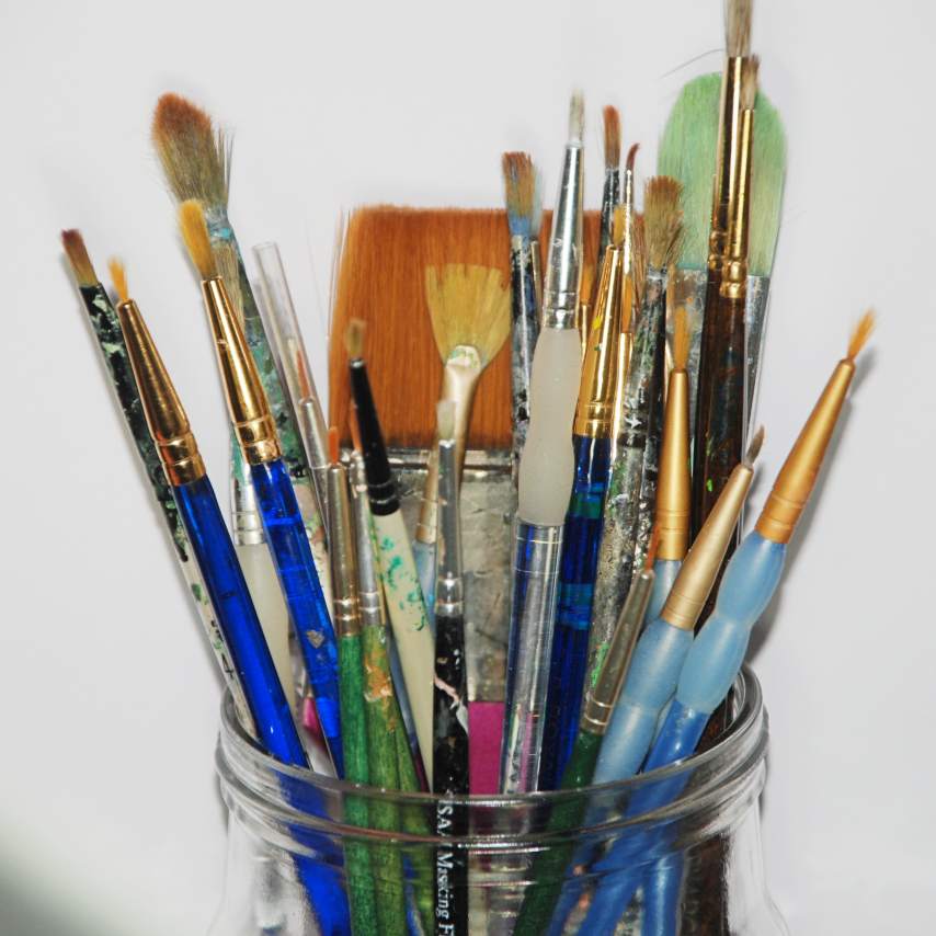 Glass jar full of synthetic paintbrushes