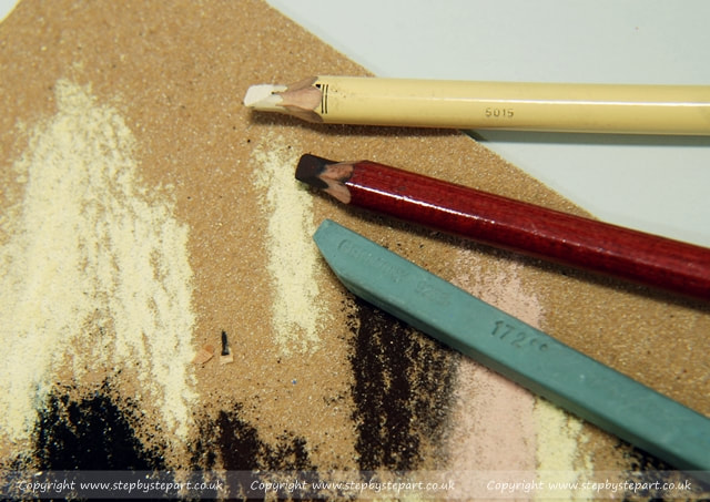 Stabilo & derwent pastel pencils and a polychromos pastel stick on fine grain sandpaper