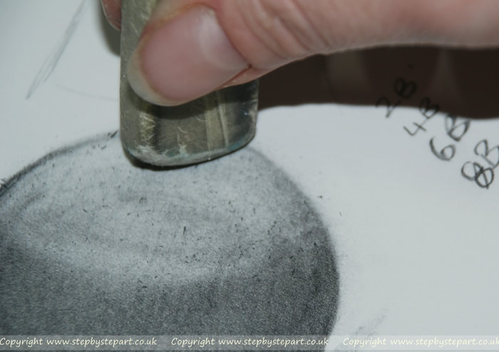 erasing graphite pencil to create highlights