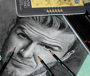 Drawing of David Beckham and Derwent graphite pencils in a tin