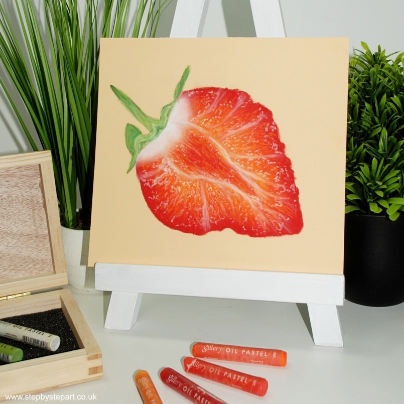 Drawing of a strawberry in oil pastels and gallery oil pastels in a wooden box